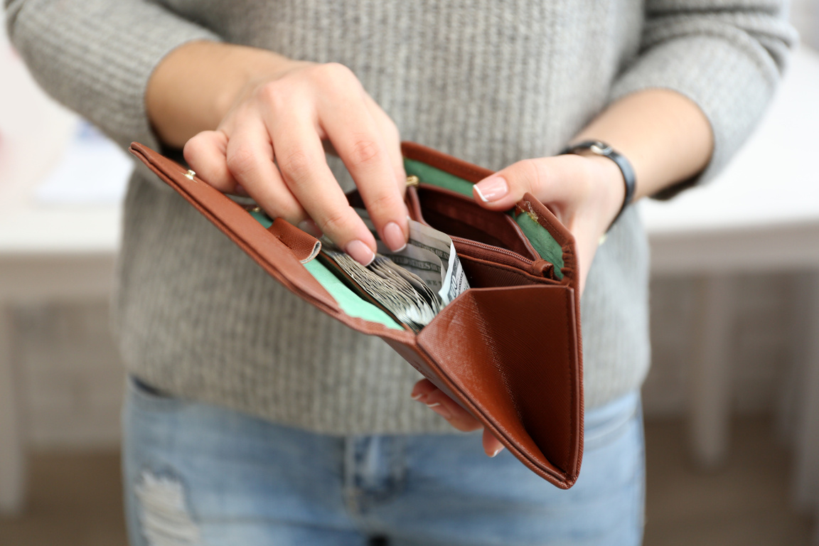 Person Taking Money from Wallet 